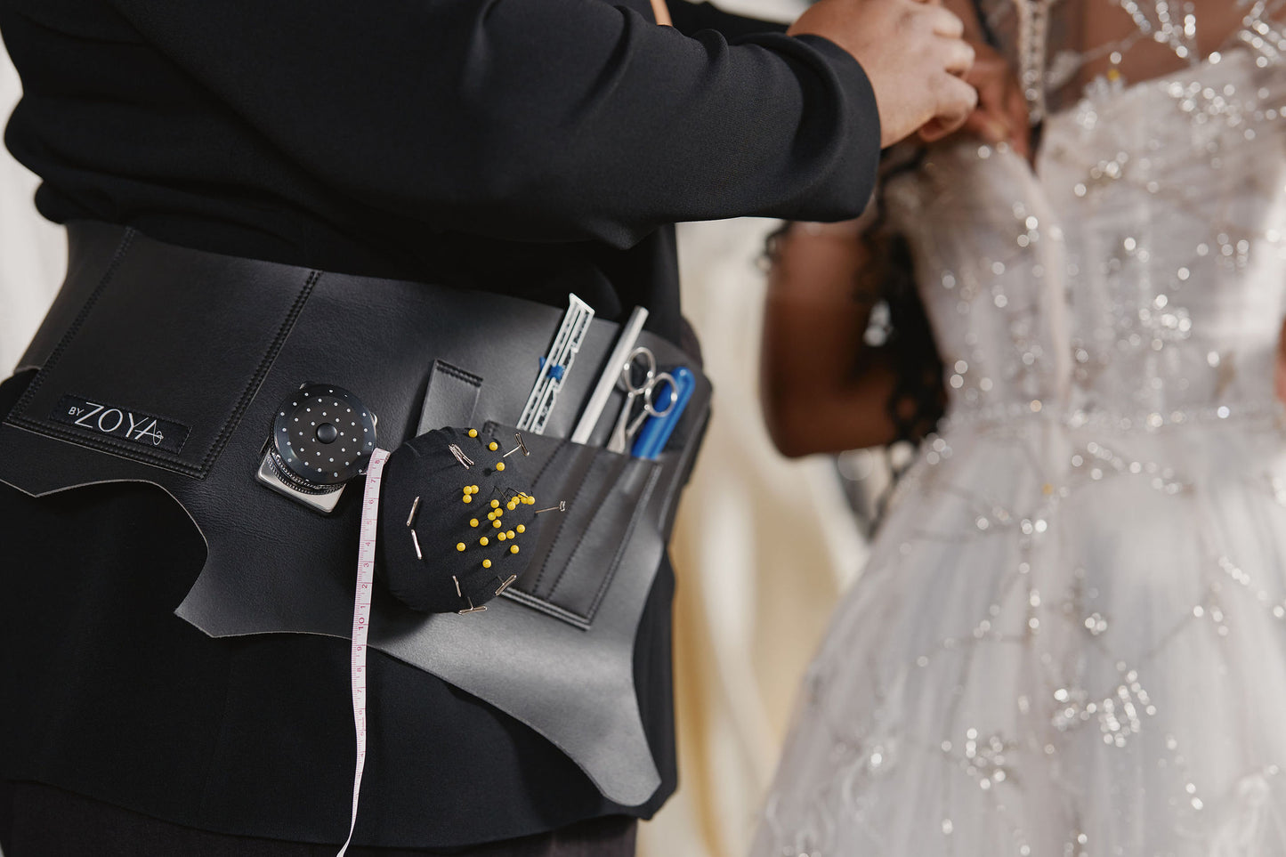 Close-up of the black Fashion's Toolbelt wore by a Zoya's fashion designer